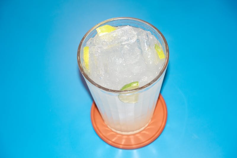 Fresh squeezed lemonade in a tall glass with ice and mint