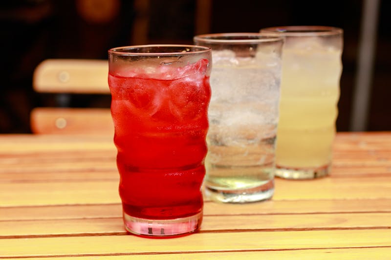 Colorful Italian soda with cream and cherry on top